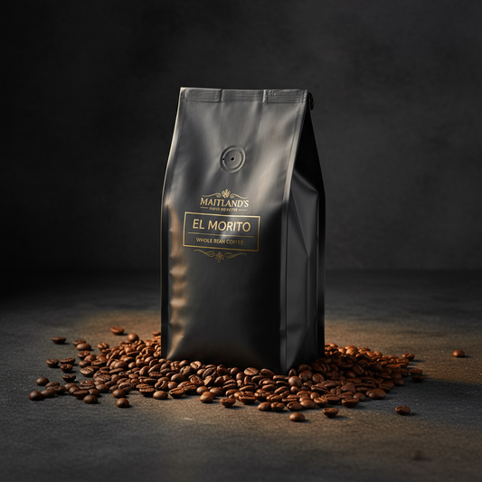 El Morito Whole Bean Coffee bag on dark slate with dramatic golden lighting